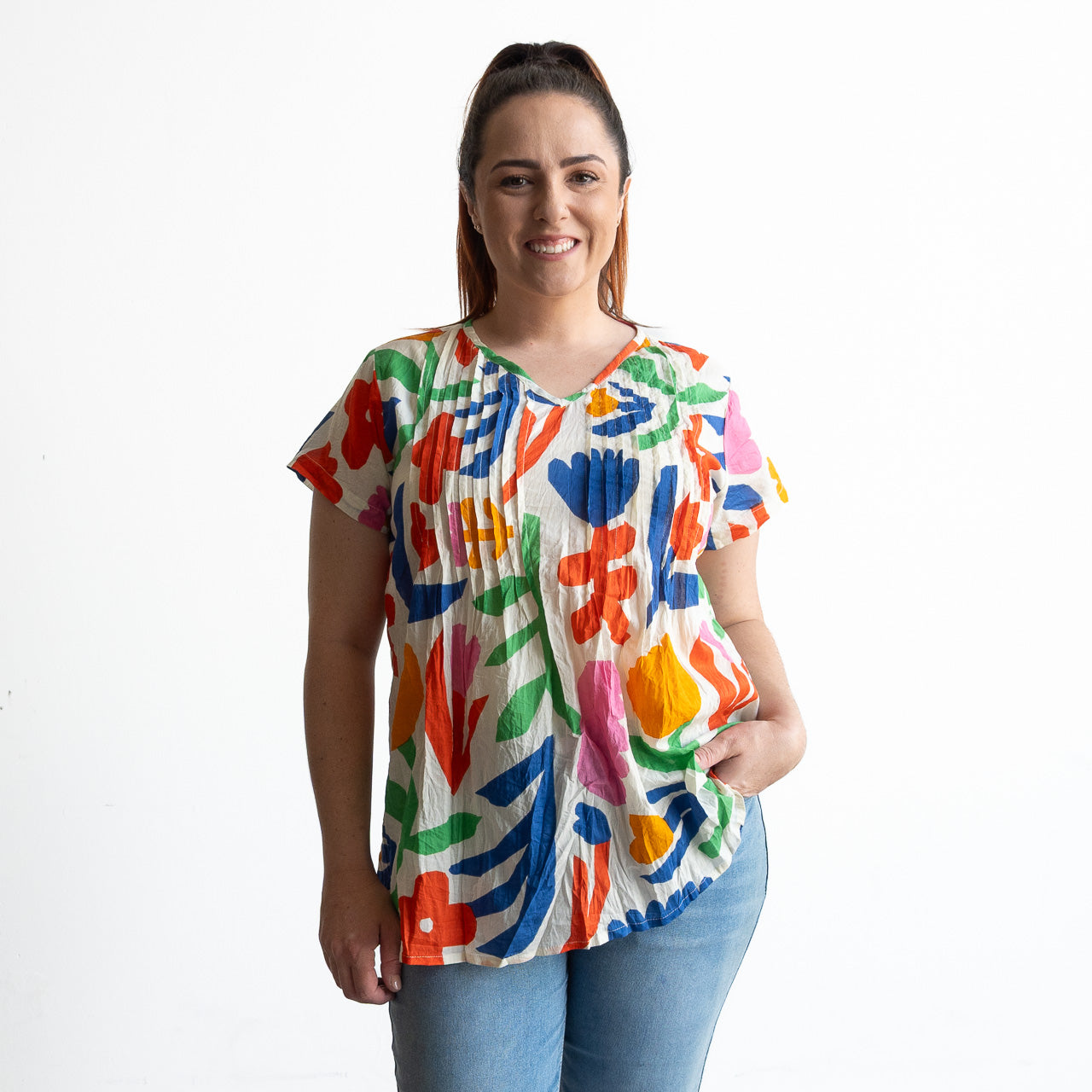 Woman wearing a colorful light cotton pintuck floral blouse 