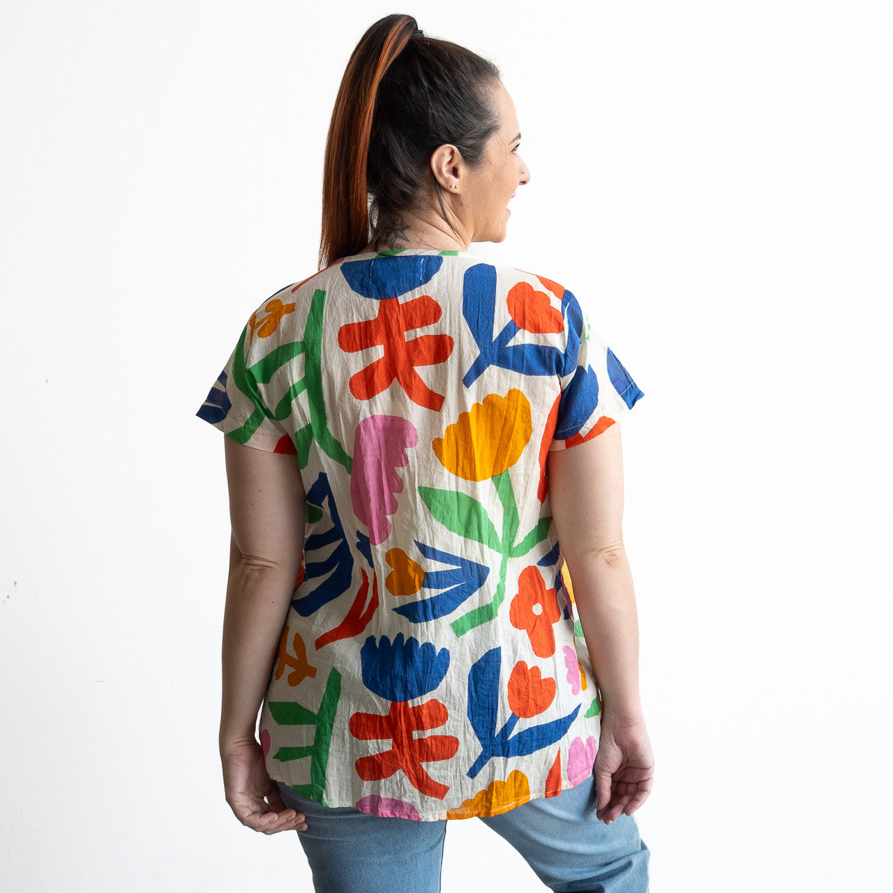 Woman wearing a colorful light cotton pintuck floral blouse 