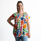 Woman wearing a colorful floral-patterned blouse with crinkle cotton texture