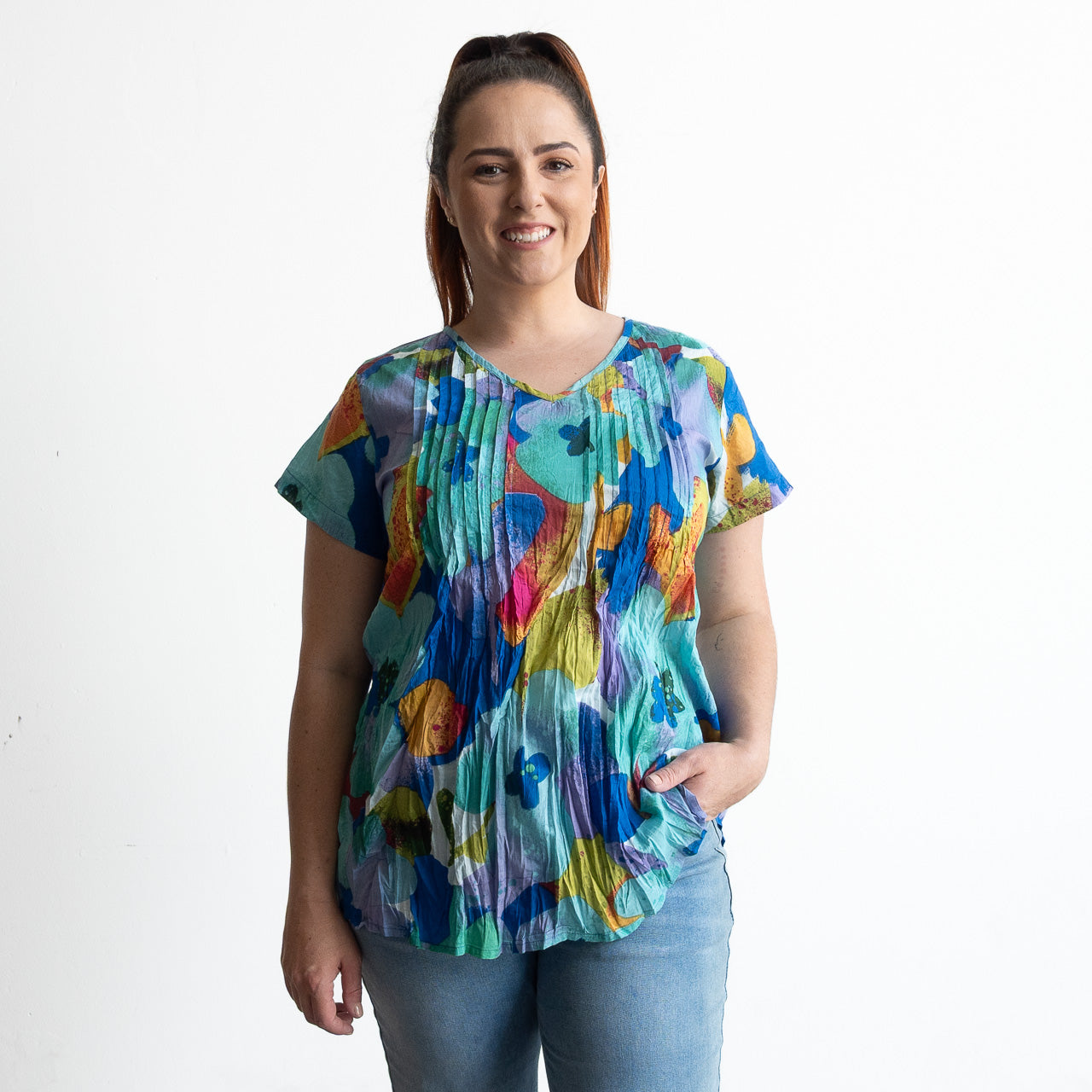 Woman wearing turquoise blue watercolour floral top in light crinkle cotton