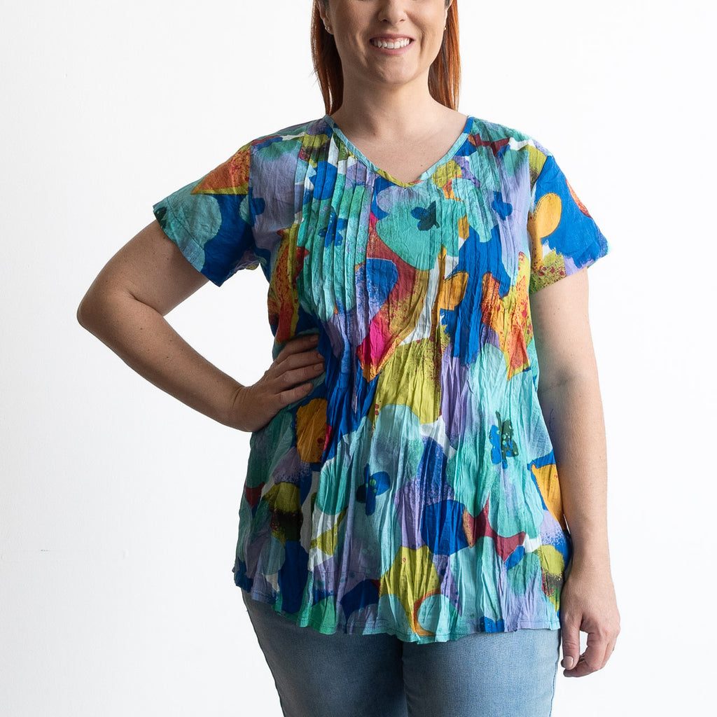 Woman wearing turquoise blue watercolour flora top in light crinkle cotton