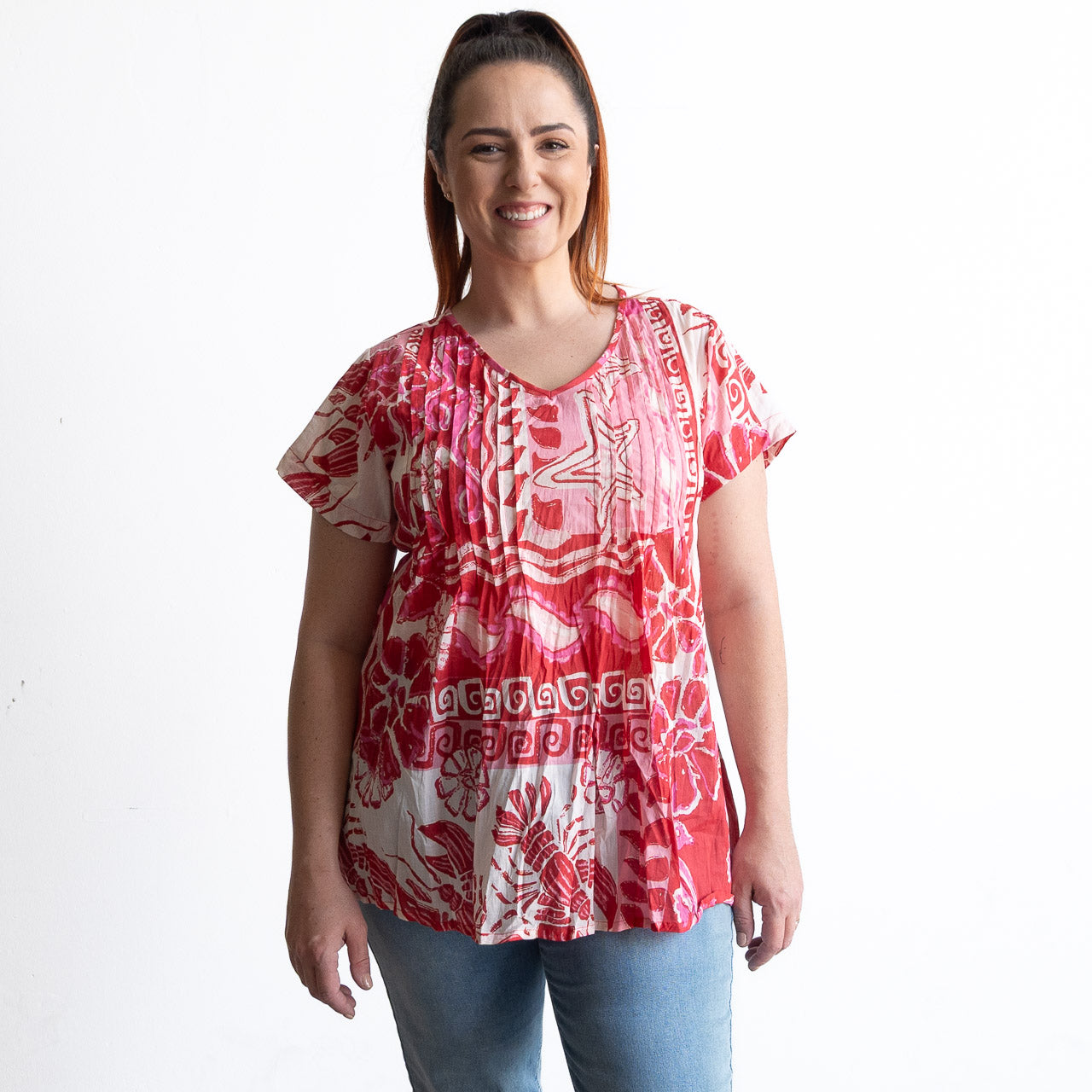 Woman wearing a red and white cotton top with crinkle texture