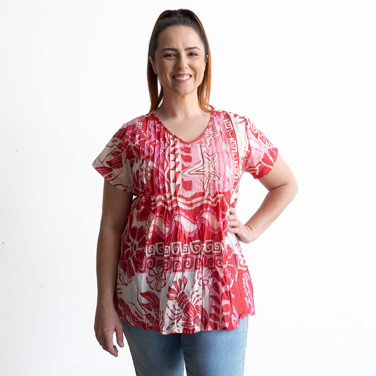 Woman wearing a red and white cotton top with crinkle texture