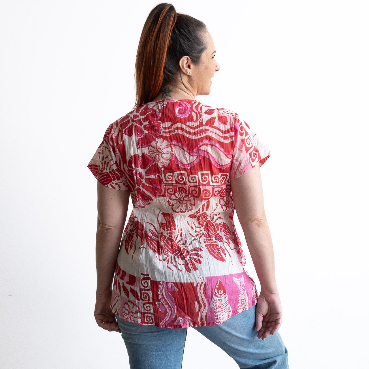 Woman wearing a red and white cotton top with crinkle texture