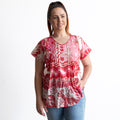 Woman wearing a red and white cotton top with crinkle texture