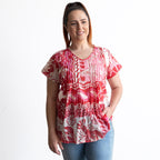 Woman wearing a red and white cotton top with crinkle texture
