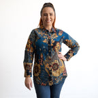 Woman wearing a colorful floral patterned shirt on a white background