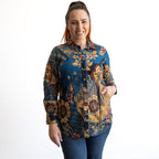 Woman wearing a colorful patterned shirt on a white background