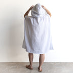 Oversized Noosa Beach Hoodie in cotton, knee-length with a hood and long sleeves, worn with brown slip-on sandals.
