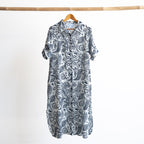 Button-through classic collared cotton shirt dress in navy and white illustrated botanical print. Midi length hemline.