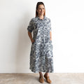 Button-through classic collared cotton shirt dress in navy and white illustrated botanical print. Midi length hemline.