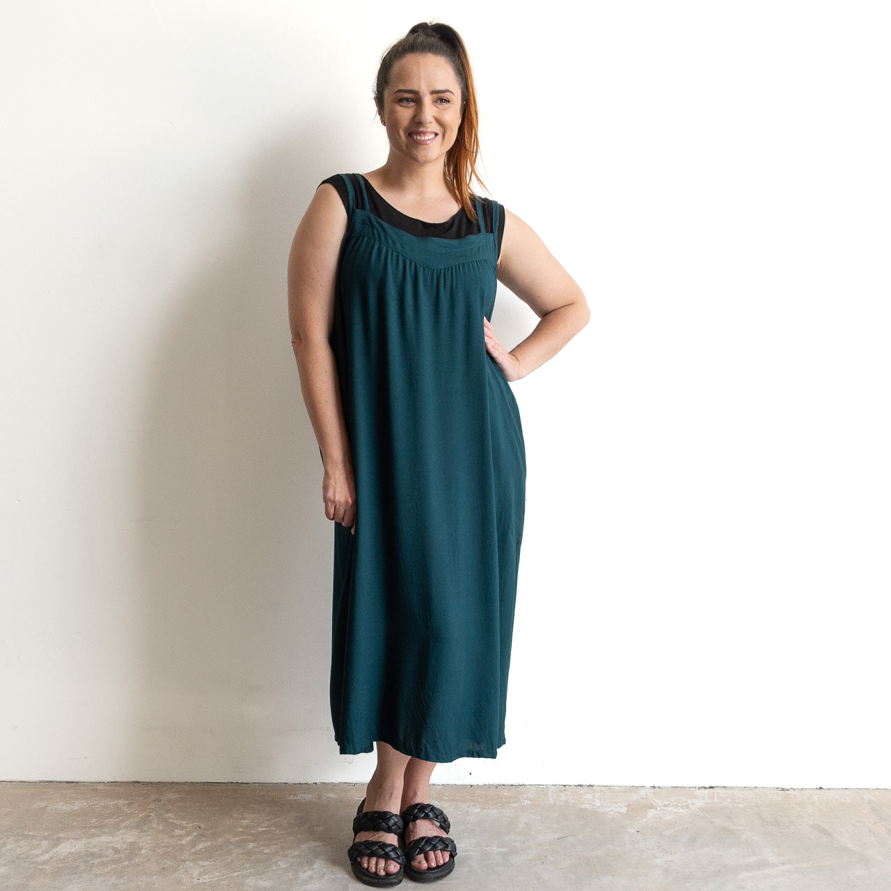 Shoestring midi sundress in a loose style in peacock green layered over a black bamboo tshirt