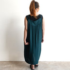 Shoestring midi sundress in a loose style in peacock green layered over a black bamboo tshirt