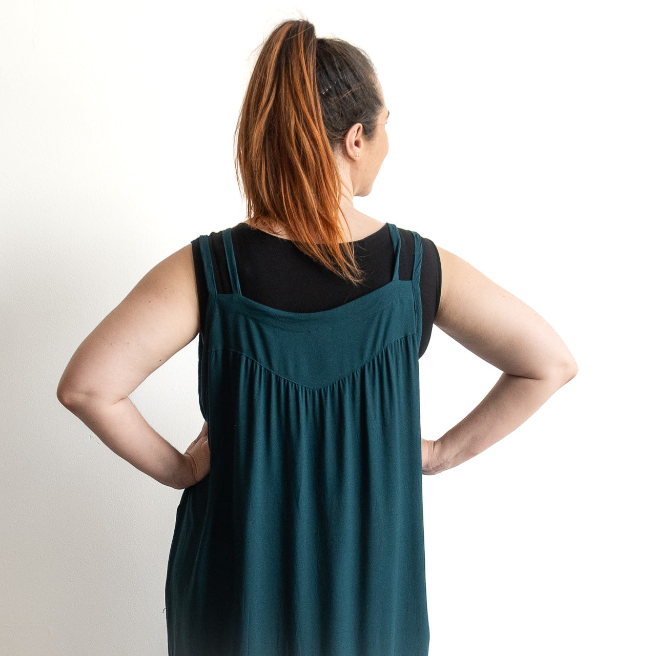 Shoestring midi sundress in a loose style in peacock green layered over a black bamboo tshirt