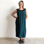 Shoestring midi sundress in a loose style in peacock green layered over a black bamboo tshirt