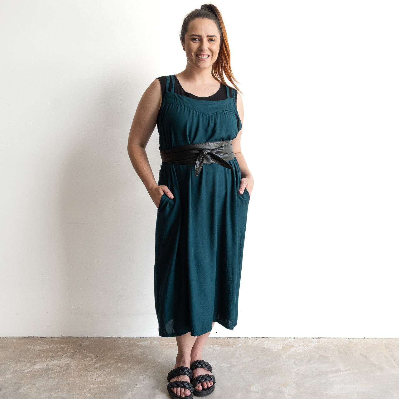 Shoestring midi sundress in a loose, belted style in peacock green layered over a black bamboo tshirt