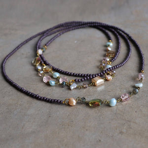 Long strand necklace that can be layered up to 3 times around.  Handmade in all glass beads with baroque pearl highlights.