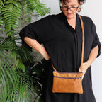 Handmade genuine leather shoulder handbag. Adjustable strap with zippered compartments for phones and make-up. 23cm x 15cm in size. Tan.