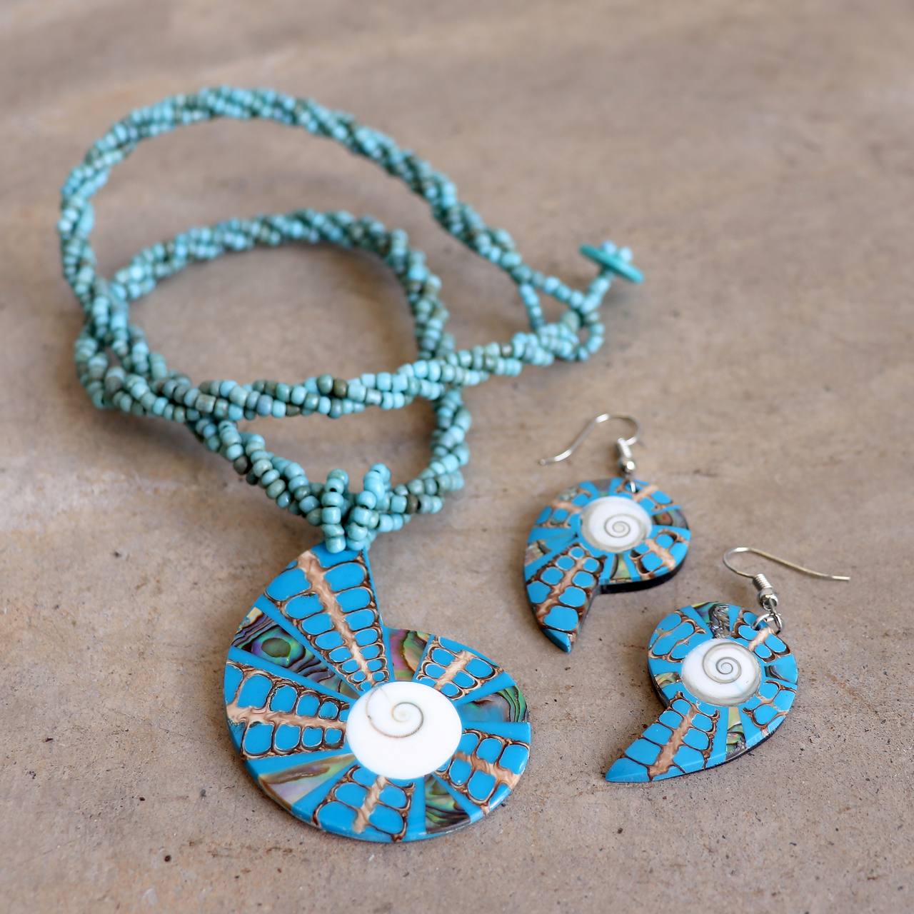 By The Sea Shore Necklace made with mother-of-pearl and glass beads in a tortoise shell pattern. Shell-Blue.