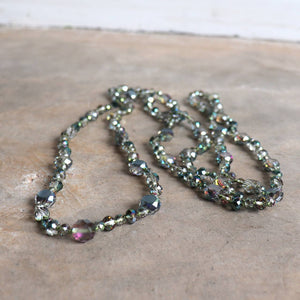 Stunning luxe-length, hand-knotted necklace made with faceted glass beads in a rainbow metallic finish. Sage Green.