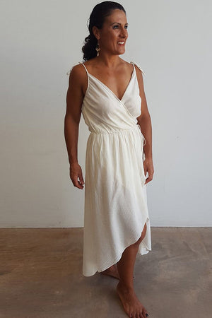 100% cotton spaghetti strap summer boho wrap dress with adjustable ties. Natural white.