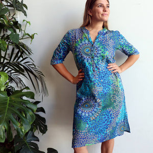 Women's long kurta tunic dress featuring a mandarin collar dipping into a flattering V. Designed locally and ethically produced and handmade by our team in a striking purple mandala print. Available in sizes S-XXXL. Blue.