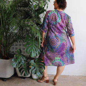 Women's long kurta tunic dress featuring a mandarin collar dipping into a flattering V. Designed locally and ethically produced and handmade by our team in a striking purple mandala print. Available in sizes S-XXXL.