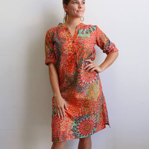 Women's long kurta tunic dress featuring a mandarin collar dipping into a flattering V. Designed locally and ethically produced and handmade by our team in a striking rust orange mandala print. Available in sizes S-XXXL. 