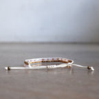 Classic art deco styling, featuring two rows of fine brass and glass beads all hand-knotted using traditional ethnic techniques. Gold & Pink Medley.
