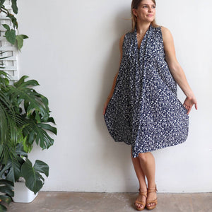 Origami Dress in floral print is a sleeveless trapeze sundress in black or navy blue. Hemline view.