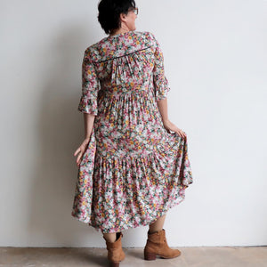Our Sunday Best Midi Dress is flowing floral frock in a long, classic boho style. Back view.