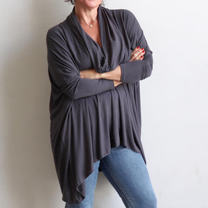 Our Glider Poncho Tee made in bamboo is a cowl neck plus size winter kaftan top. Charcoal grey. Arms view.
