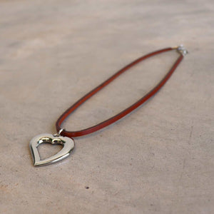 Heart shaped silver pendant combined with a natural leather band available in 3 colours, Black, Silver and Tan