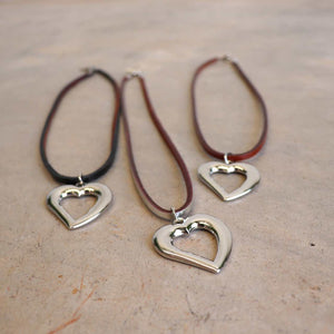 Heart shaped silver pendant combined with a natural leather band available in 3 colours, Black, Silver and Tan.