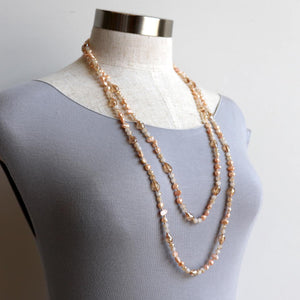Freshwater pearls and cut glass beads. Hand knotted. 155cm full length. Champagne.