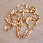 Freshwater pearls and cut glass beads. Hand knotted. 155cm full length. Rose.