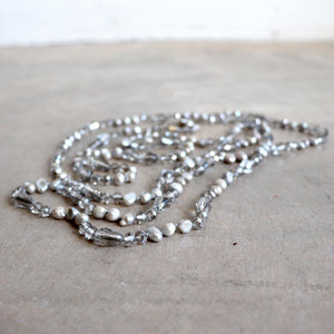 Freshwater pearls and cut glass beads. Hand knotted. 155cm full length. Silver.