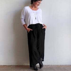 Zen Drawstring Lounge Pants - Classic black wide-leg, pull-on trousers in plus-size fitting. Karen wearing size L/XL.