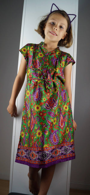 Girl's cotton shirt dress with cap sleeve. Green and purple paisley print made with sari fabric. Sizes baby to tweens.