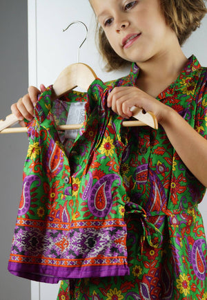 Girl's cotton shirt dress with cap sleeve. Green and purple paisley print made with sari fabric. Sizes baby to tweens.